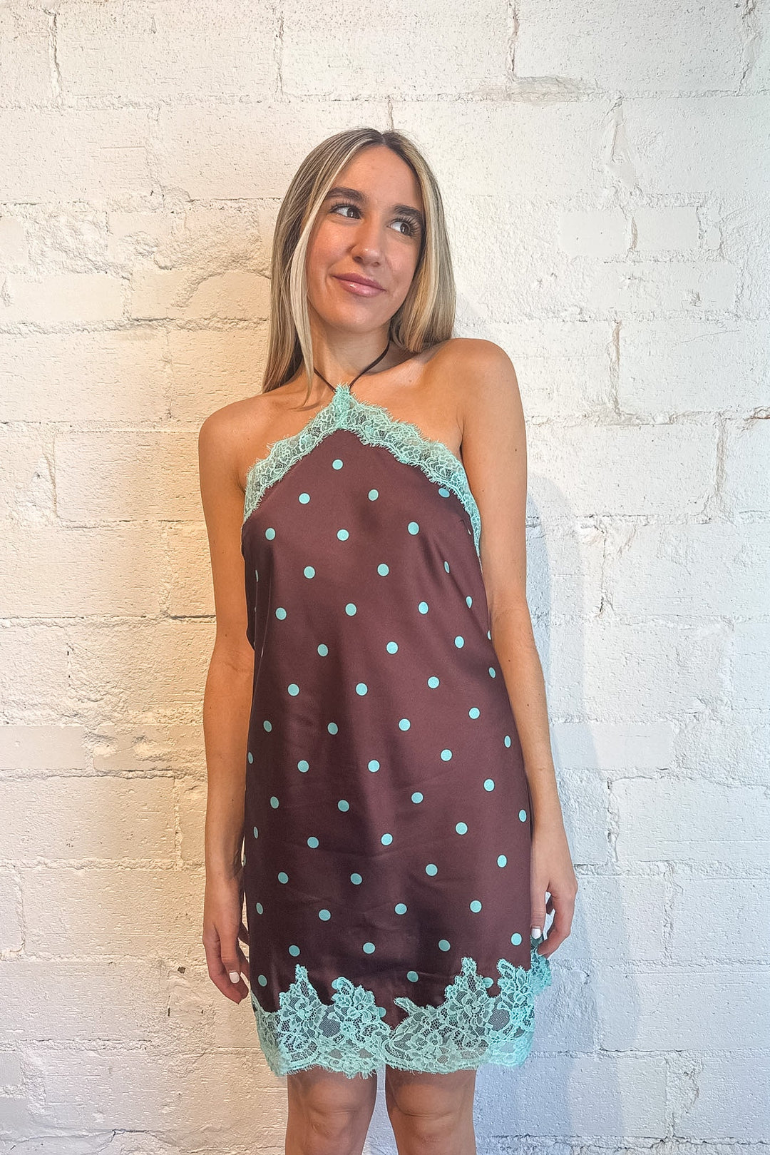 brown mini dress with teal polka dots and lace detailing