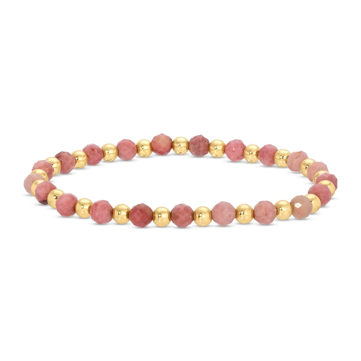 Bracelet with pink beads and gold accents on a white background